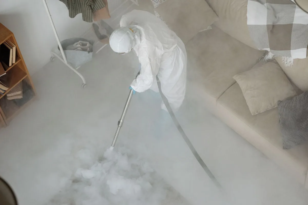 Biohazard cleanup technician in protective equipment, East End, AR